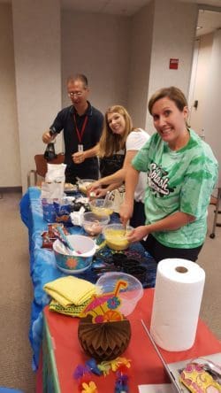 teachers participate in a mock cooking show during their summer training