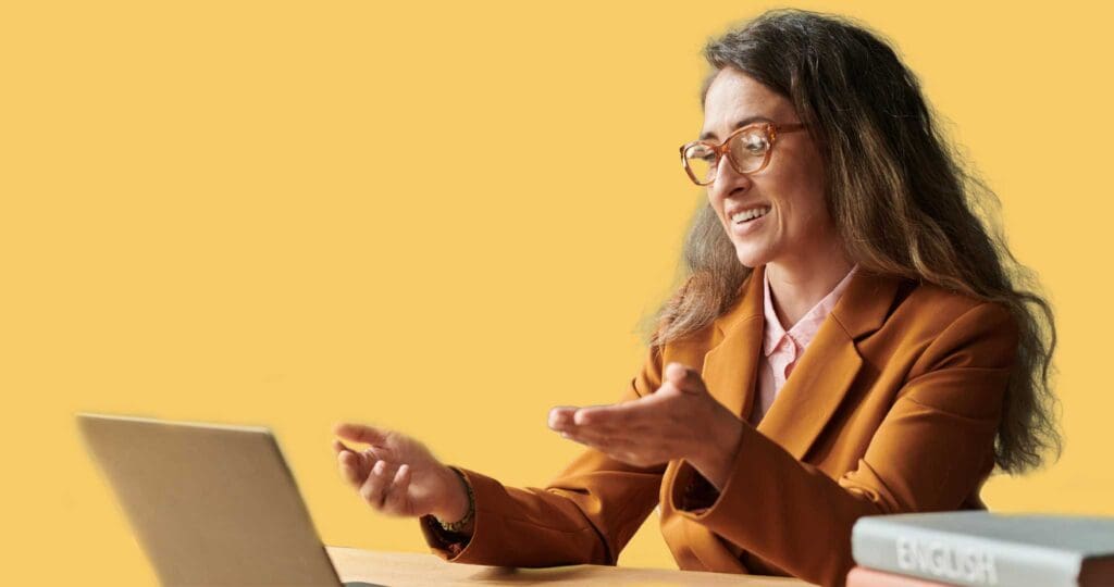 Teacher, teaching remote to a computer screen.
