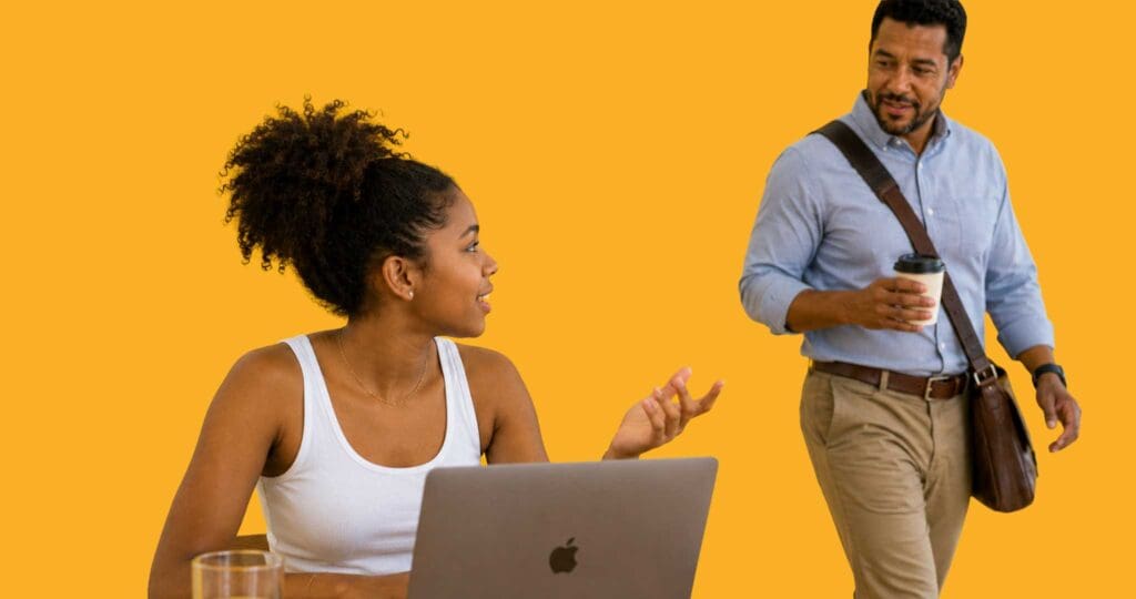 Student at laptop asking for assistance from teacher