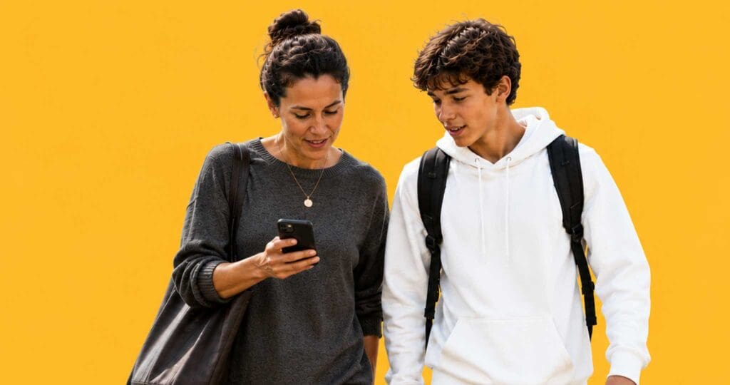 An Adult and a kid look at the adults phone.