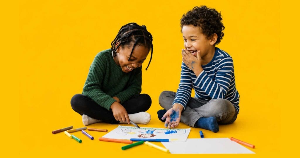 Two young kids coloring together